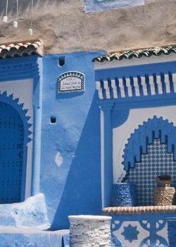 A blue and white building with steps leading up to it