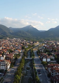 An aerial view of a city with mountains in the background