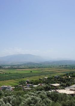 An aerial view of a small town with mountains in the background