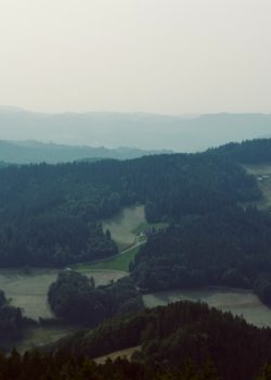 Mountains and rolling hills fade into the horizon.
