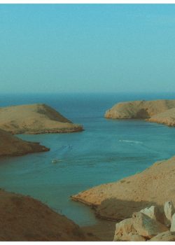 a body of water surrounded by rocky hills