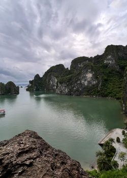 a body of water with a boat in it and a bridge over it