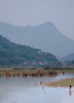 a body of water with mountains in the background