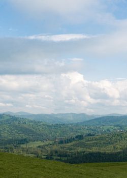 a grassy hill with a small hut on top of it