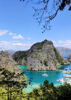 a group of boats floating on top of a lake