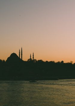 a large body of water with a church in the background