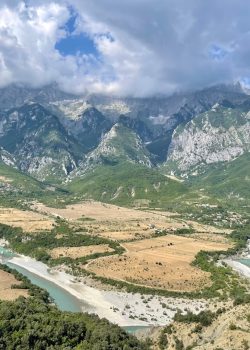 a river running through a valley between mountains
