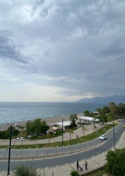 a road with cars on it next to a body of water