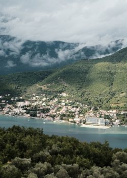 a scenic view of a town and a body of water