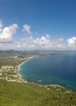 a scenic view of a tropical island and the ocean