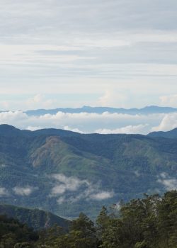 a view of a mountain range with clouds in the sky