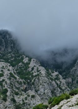 a view of a mountain with low lying clouds