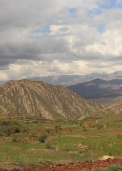 a view of a valley with mountains in the background