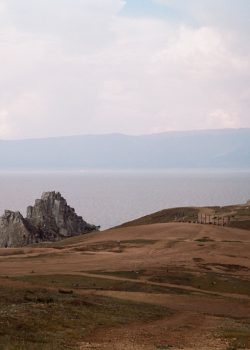 brown and green mountains near body of water during daytime
