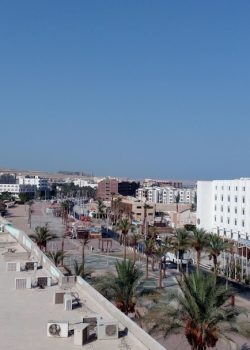 cars parked on parking lot near buildings during daytime