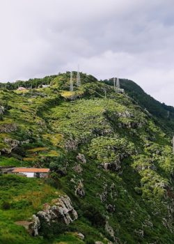 mountain near road under white clouds